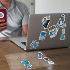 Jumbo Domed stickers on notebooks and mobile phones with the card on the table Jumbo Domed stickers on notebooks and mobile phones with the card on the table