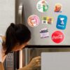 Woman opening fridge with magnets Woman opening fridge with Custom Magnets
