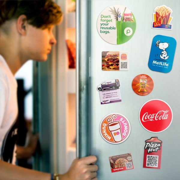 Young man opening fridge with magnets Young man opening fridge with magnets